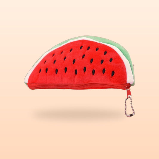 Red watermelon plush pencil case with black seeds and a bead chain zip pull, on a soft peach background