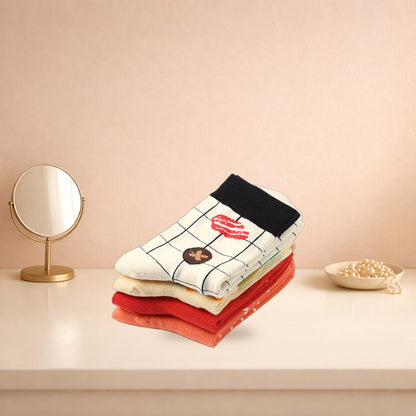 Four folded Japanese food print socks stacked on a cream dressing table