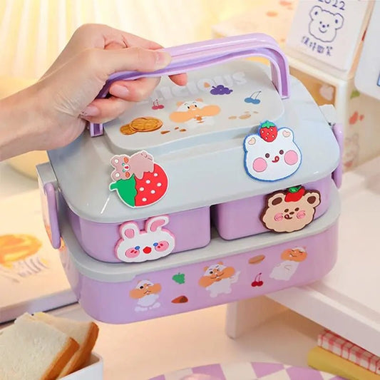 Purple two-tier bento box with bunny and strawberry stickers, carried by its handle
