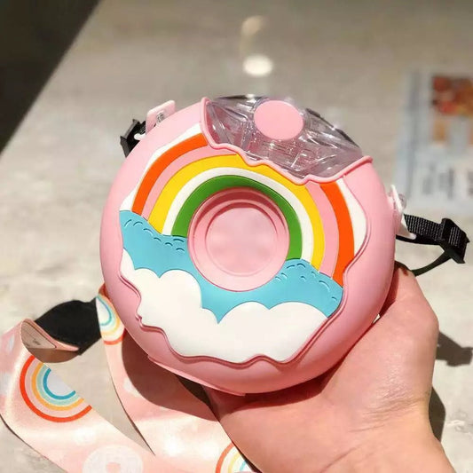 Rainbow Pink donut kids straw bottle with rainbow and clouds, held in hand