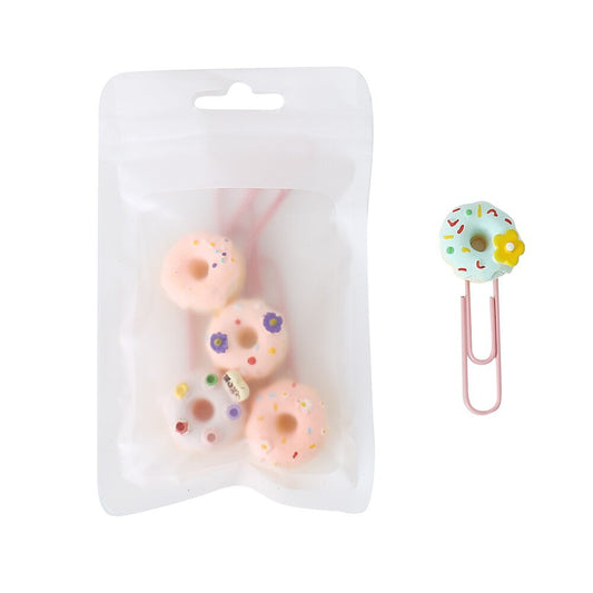 Three donut paper clips in a clear resealable pack with one blue donut clip beside it
